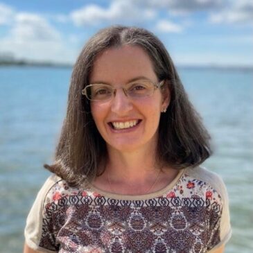 Pilar has the widest, sparkling smile! Her shoulder length hair sweeps a beautiful patterned sweater and she is standing in front of an incredible blue bay! Pilar is a native Columbian woman with just the tiniest dignified touch of grey in her shoulder length dark hair. That laughter in her eyes, though! I'll bet her sweet little dog is at her feet as the photo is taken.