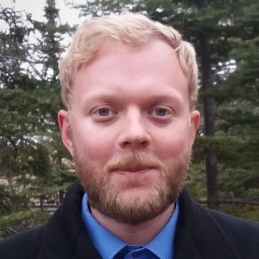 Paul Peterson invites us to join him on a walk through an evergreen woods. He's dressed for professoring in jacket and button down with trim blond beard and hair, but he's leading us away from the comforts of civilization into the mysteries of the languages of the past!