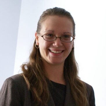 Dr. Faith Acker clearly looks at home in the depths of the forbidden region of arcane libraries, with her professional jacket and serious glasses, but that smile just invites everyone along for the adventure!